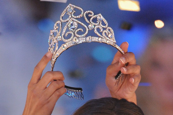 NICE, FRANCE - DECEMBER 05: Miss Normandie Malika Menard (L) receives the crown from 2009  Miss France Chloe Mortaud (R) during the 2010 Miss France Beauty pageant at Palais Nikaia on December 5, 2009 in Nice, France.  (Photo by Pascal Le Segretain/Getty Images) *** Local Caption *** Malika Menard;Chloe Mortaud