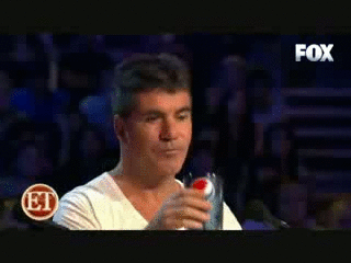 Simon Cowell almost chokes on his drink laughing at X-Factor